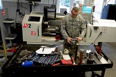 Illinois Army National Guard Sgt. Wesley Todd, of La Porte, Indiana checks the measurements on the device he invented at the machine shop in the Combined Support Maintenance Shop in North Riverside, Illinois, Sept. 21, 2016. Illinois Army National Guard photo by Staff Sgt. Robert R. Adams