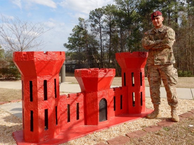 Army Sgt. Ali Alsaeedy, a paratrooper assigned to the 307th Brigade Engineer Battalion, 3rd Brigade Combat Team, 82nd Airborne Division, poses for a photo in front of his unit's engineer castle at Fort Bragg, N.C., March 3, 2017. Army photo by Staff Sgt. Anthony Hewitt