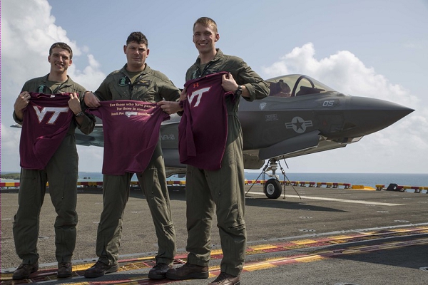 Left to right: Marine Corps aviators Capt. Evan Slusser, Maj. John Stuart and Capt. Andrew Thornberg pose for a photo aboard the amphibious assault ship USS Wasp in the Pacific Ocean, March 15, 2018. The trio are F-35B Lightning II pilots with Marine Fighter Attack Squadron 121, embarked aboard the USS Wasp. All three Marines graduated from Virginia Polytechnic Institute and State University, also known as Virginia Tech, in Blacksburg, Va. Marine Corps photo by Cpl. Bernadette Wildes
