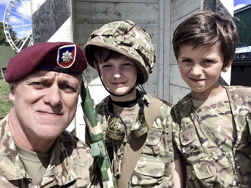 Army Lt. Col. John Hall, a public affairs officer with the 173rd Airborne Brigade Combat Team in Vicenza, Italy, takes a selfie with French boys dressed as soldiers in Sainte-Mere-Eglise, France, June 2, 2018. Hall was participating in the D-Day commemoration and the boys were playing as guards at a campground near the American forces. Photo by Lt. Col. John Hall