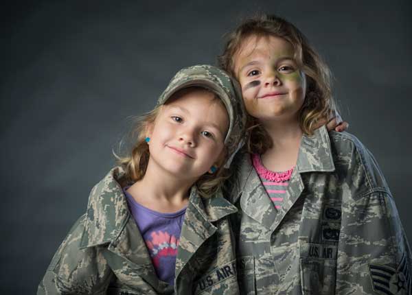 Ava and Sierra, daughters of Staff Sgt. Andrew Stevens, embrace each other on Fort Meade, Md. U.S. Photo by Staff Sgt. Vernon Young Jr.