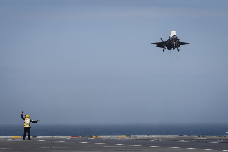 Leading Airman (Aircraft Handler) James Hope recovers the first-ever F-35B Lightning II jet to make a vertical landing onboard HMS Queen Elizabeth. Photo: Lt. Cdr. Lindsey Waudby, Royal Navy