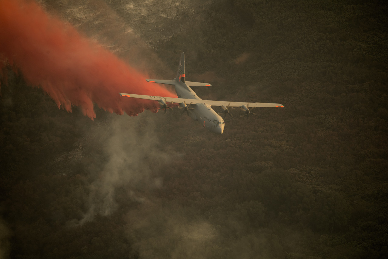 An Air National Guard C-130J Super Hercules aircraft, equipped with the Modular Airborne Fire Fighting System, drops a chemical fire retardant on the Thomas Fire in the hills above the city of Santa Barbara, Calif., Dec. 13, 2017. The C-130J from the 146th Airlift Wing supported Cal Fire’s efforts to battle the Thomas Fire raging in Southern California last year. Photo By: DOD photo
