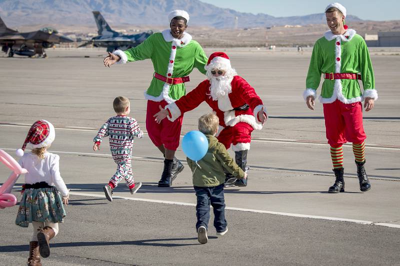 Nellis Air Force Base, Nev., Dec. 15, 2018 –  Santa Claus pays a surprise visit to family members of the Thunderbirds, the Air Force’s air demonstration squadron, during the team’s holiday party at Nellis Air Force Base.