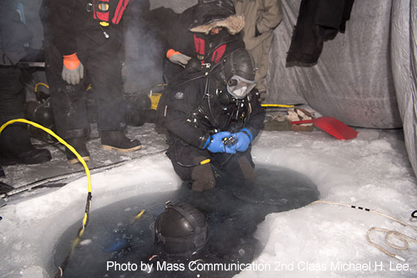 Beaufort Sea, March 10, 2018 - Navy Diver 2nd Class Christopher Corley, assigned to Underwater Construction Team (UCT) 1, prepares to dive into a water hole during a mock torpedo recovery exercise in support of Ice Exercise (ICEX) 2018.  During ICEX 2018, the Seawolf-class fast attack submarine USS Connecticut (SSN 22) from Bangor, Washington, the Los Angeles-class fast attack submarine USS Hartford (SSN 768) from Groton, Connecticut, and the Royal Navy Trafalgar-class submarine HMS Trenchant (S91) will conduct multiple arctic transits, a North Pole surfacing, scientific data collection and other training evolutions during their time in the region.
