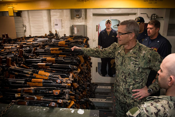 MANAMA, Bahrain, October  24, 2018 - Vice Adm. Scott Stearney, commander of U.S. Naval Forces Central Command, U.S. 5th Fleet and Combined Maritime Forces, looks at a cache of over 2,500 AK-47 automatic rifles seized during maritime security operations aboard the guided-missile destroyer USS Jason Dunham (DDG 109).